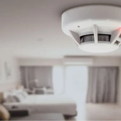 Photo of a smoke detector mounted on a ceiling