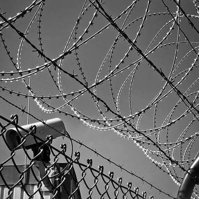 Photo of a fence with barbed wire