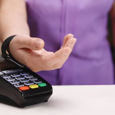 Woman making contactless payment at a store.